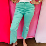 Mint cropped bootcut jeans with frayed hem and high-rise fit.