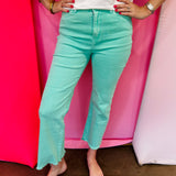 Mint cropped bootcut jeans with frayed hem and high-rise fit.