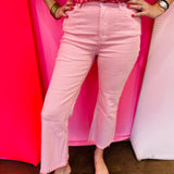 Pink cropped bootcut jeans with frayed hem and high-rise fit.