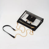 Clear crossbody bag with black trim and gold hardware, featuring a detachable sunglasses holder—fun and functional for any event.