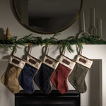 Jon Hart holiday stocking in coated canvas with leather trim and customizable leather patch for personalization.