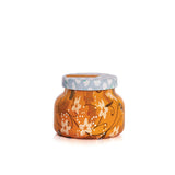 An 8oz Capri Blue Pumpkin Dulce Petite Candle with a festive holiday pattern.