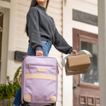 Jon Hart 360 carry-on luggage in coated canvas with leather trim and spinner wheels.