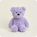 A soft, plush teddy bear with curly purple fur and a friendly face, designed to be microwavable.
